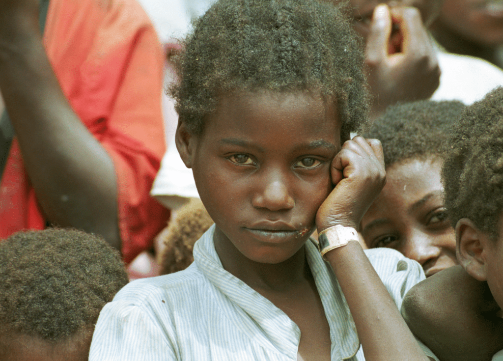 Huambo girl with hand to side of face