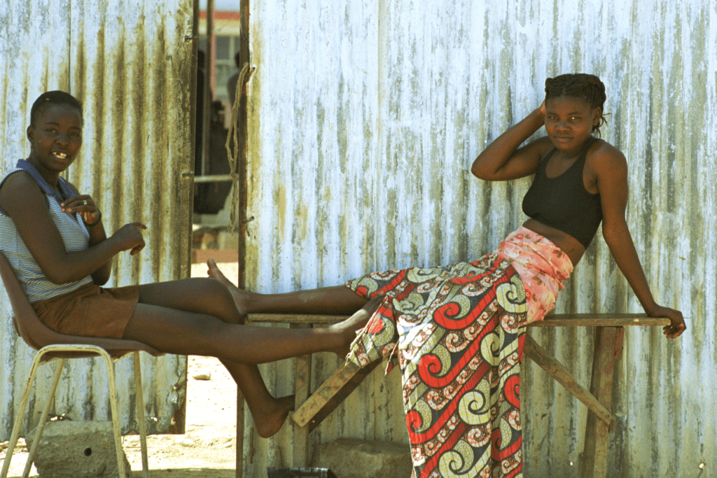 Luanda girls against sheet metal