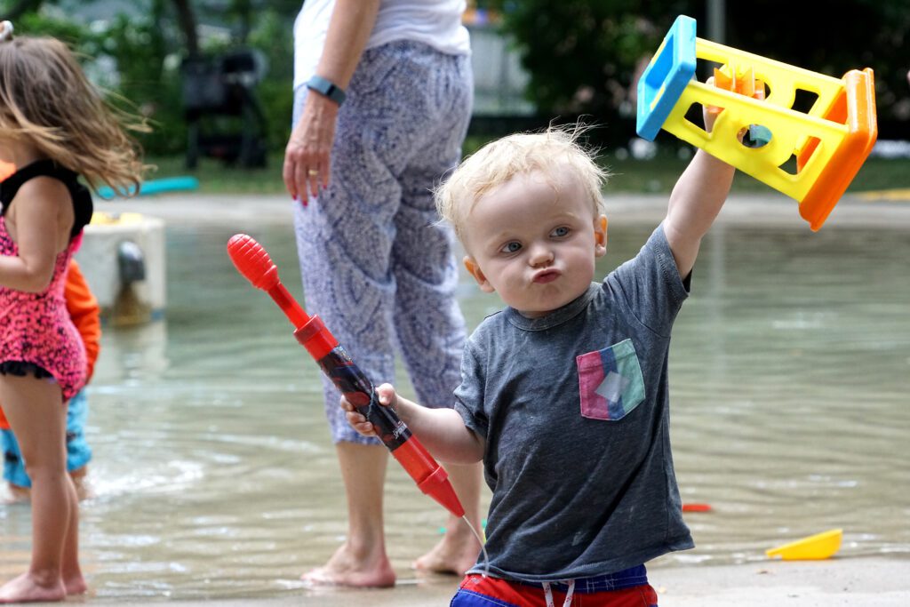 Young boy playing in the river