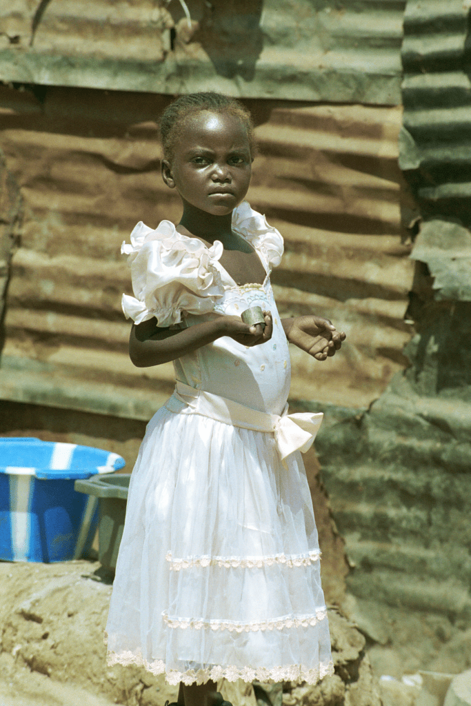 A young girl wearing pink dress