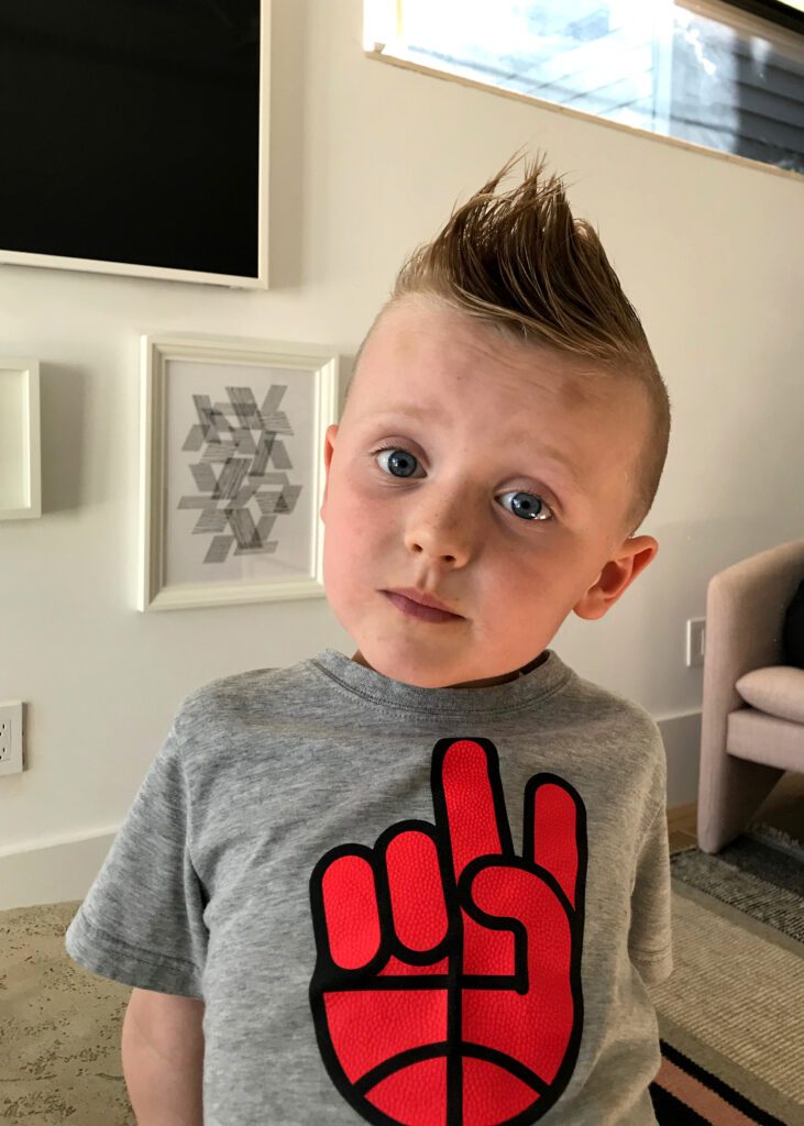 Young boy wearing peace sign shirt