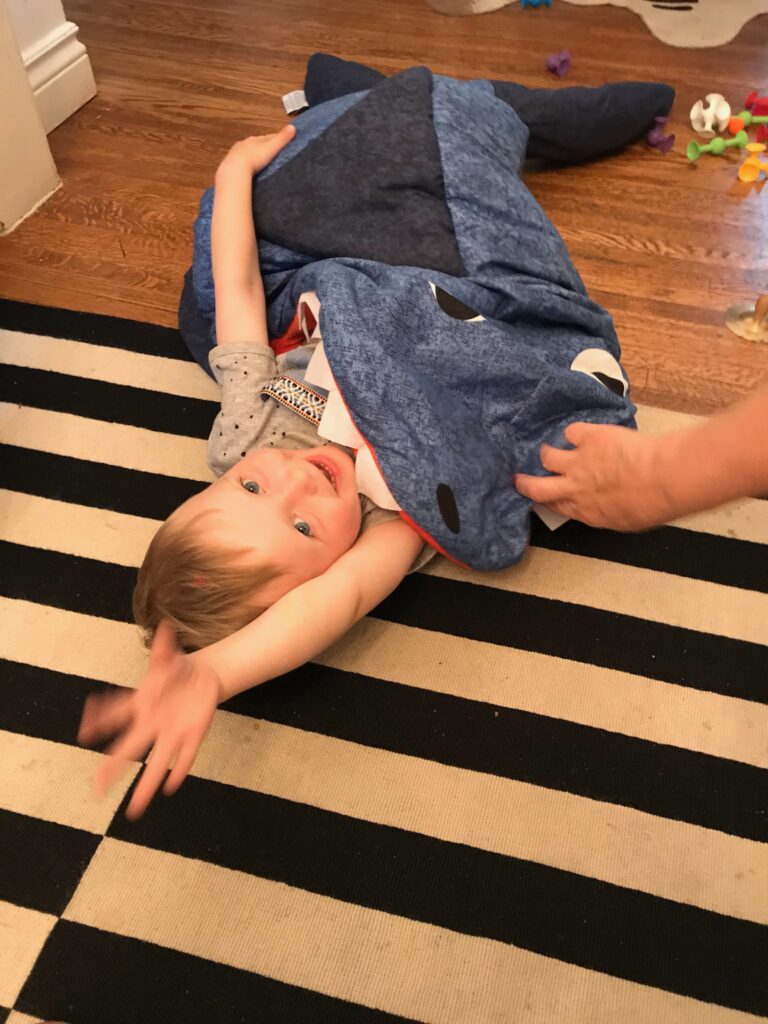 Young boy lying in the floor