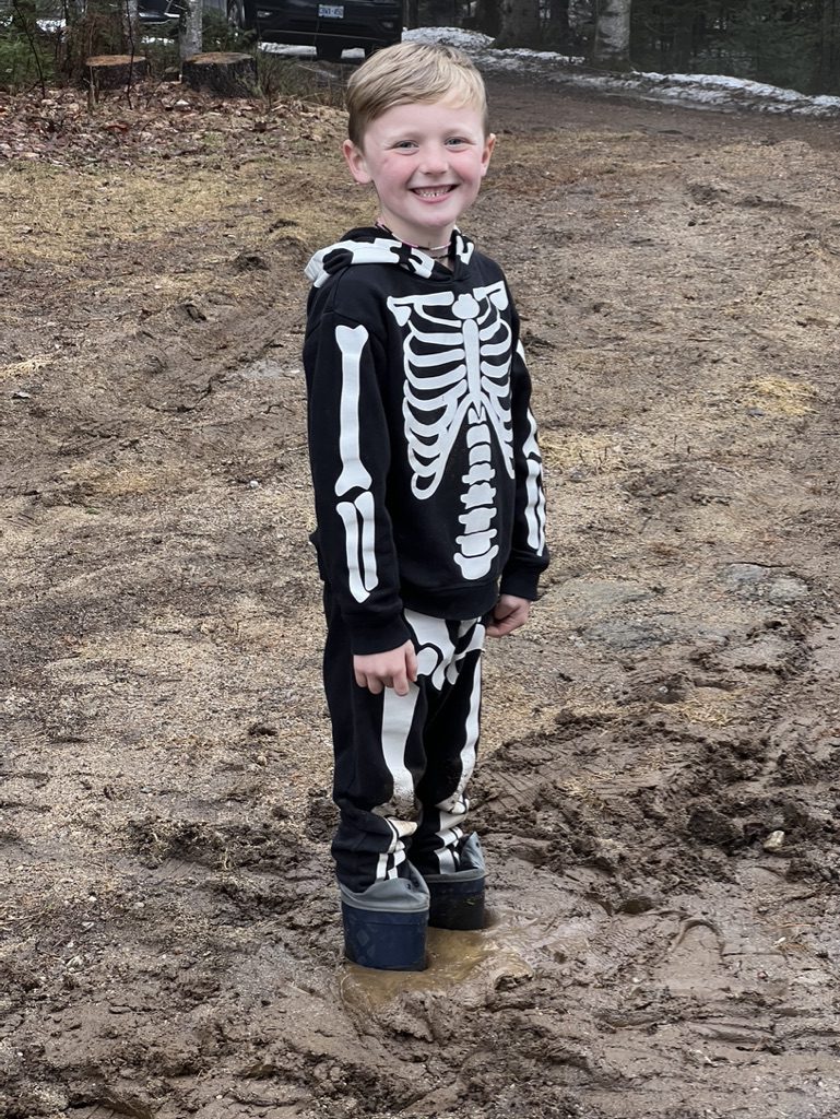 Young boy wearing skeleton costume