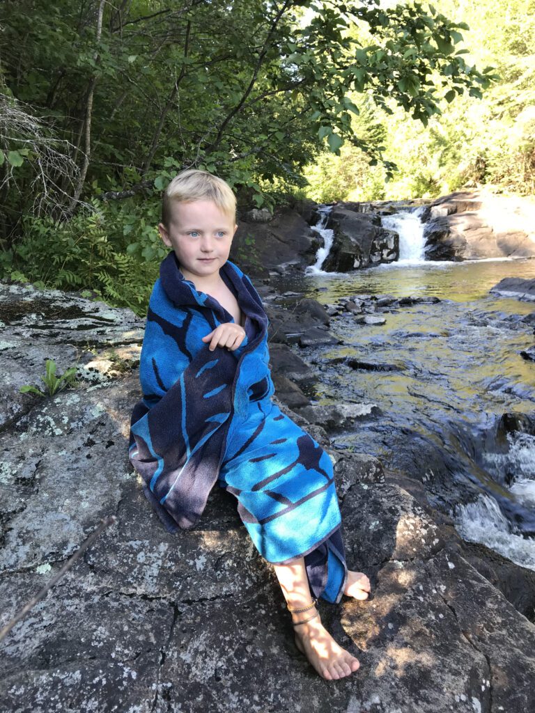 Young boy sitting on the rock