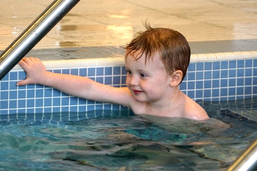 Young boy swimming in the pool