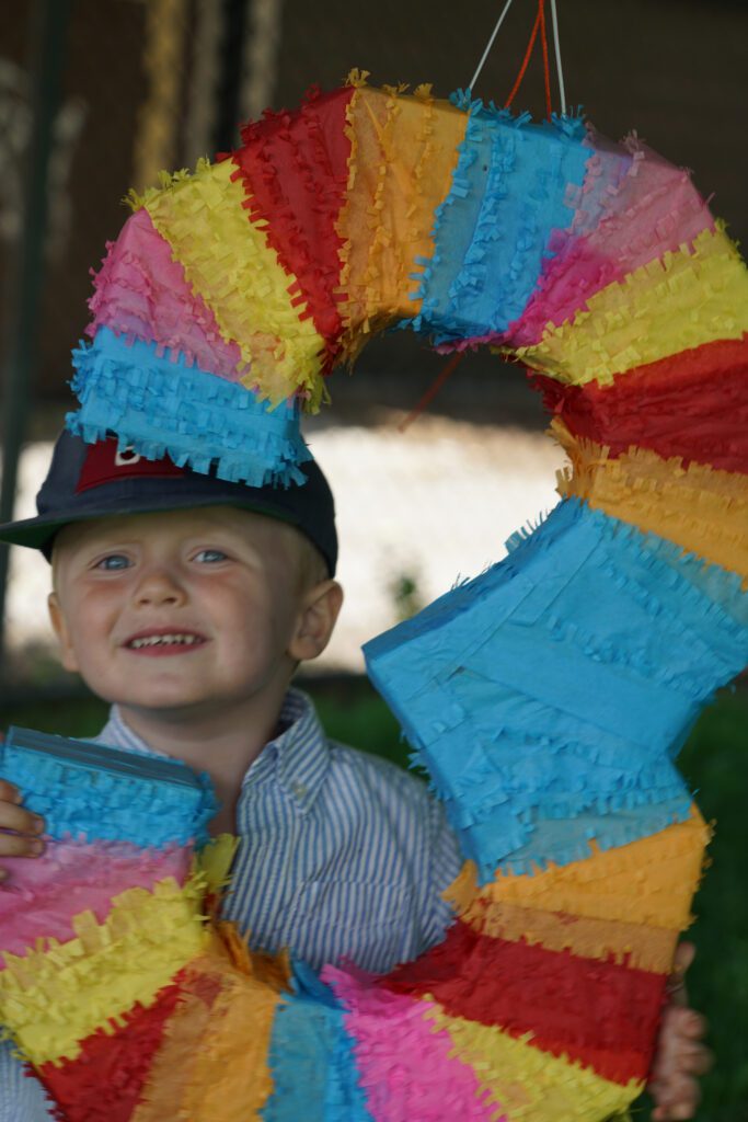 Boy smiling behind the Pinata